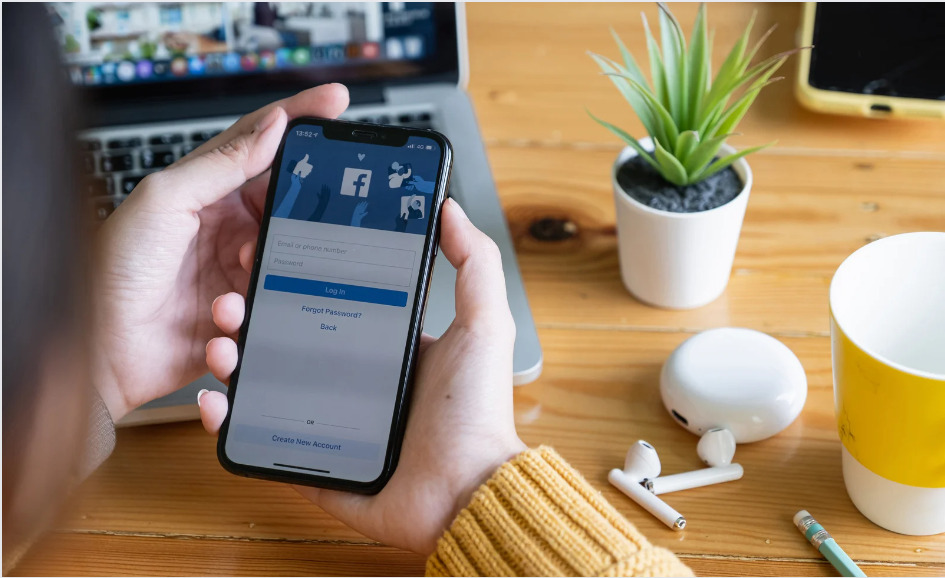 person looking at facebook on phone