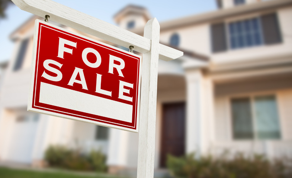 for sale sign in front of home