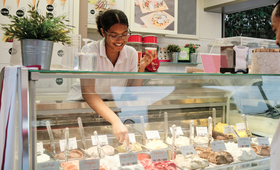 young woman scooping ice cream